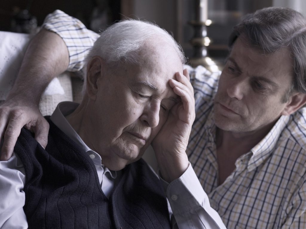 Elderly man being comforted