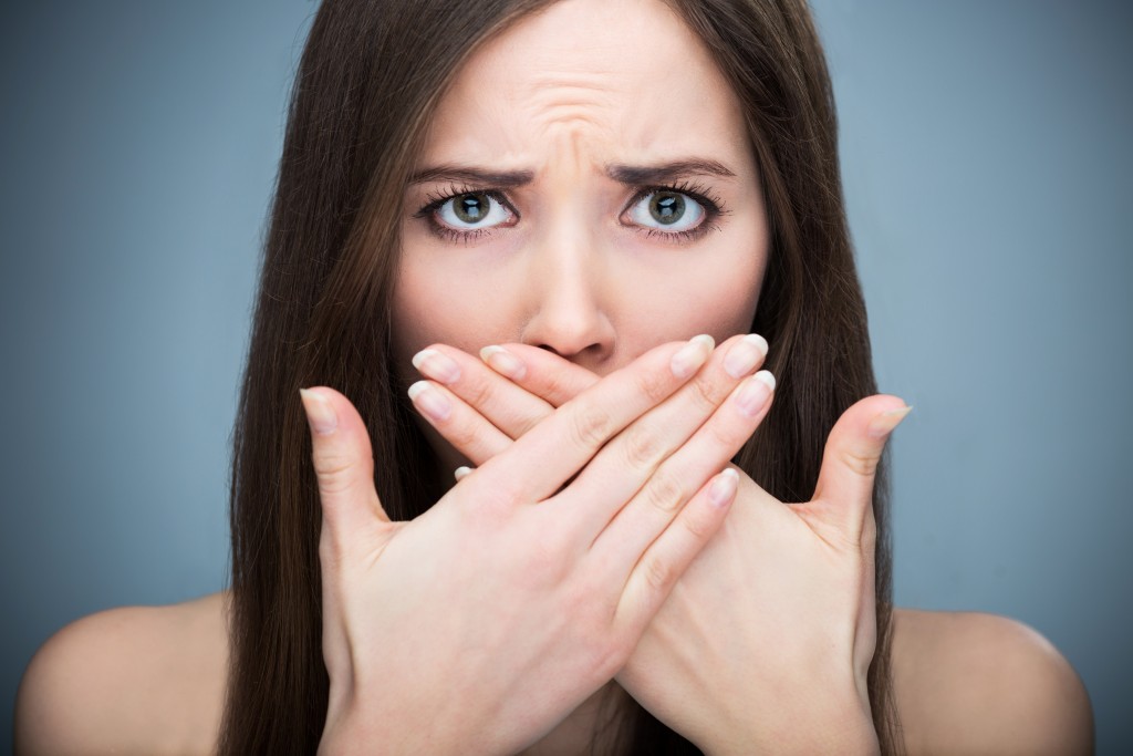 woman covering her face