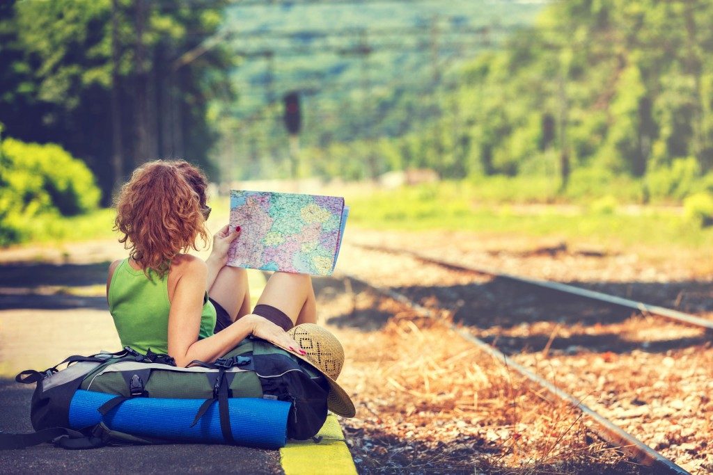 Girl wearing backpack holding map