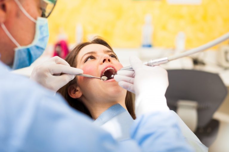 dentist performing oral surgery