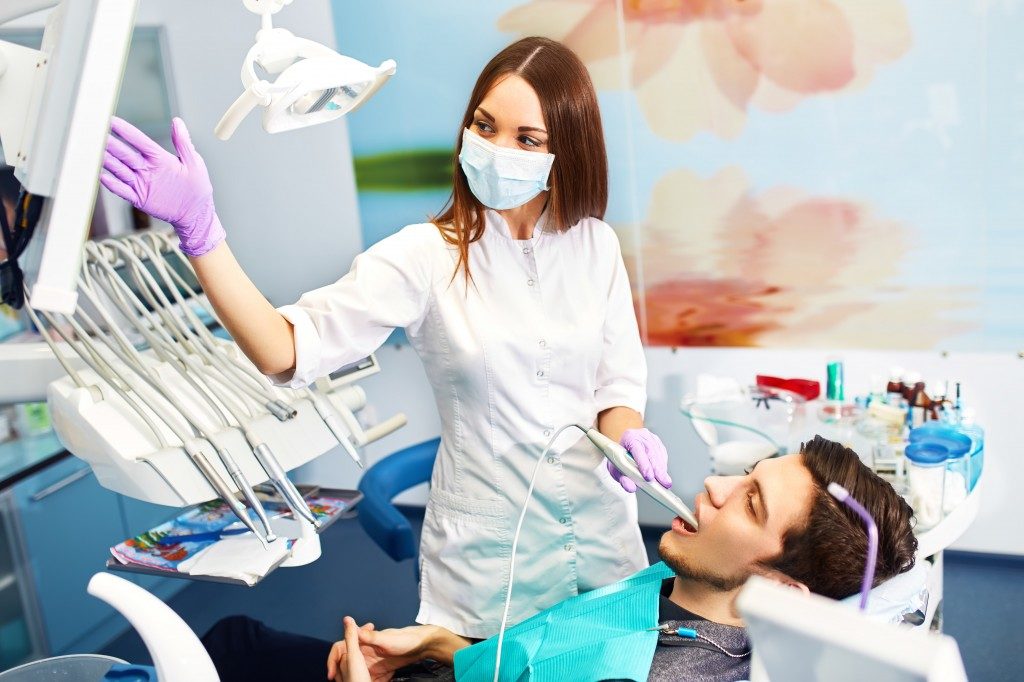 dentist showing dental xray to patient