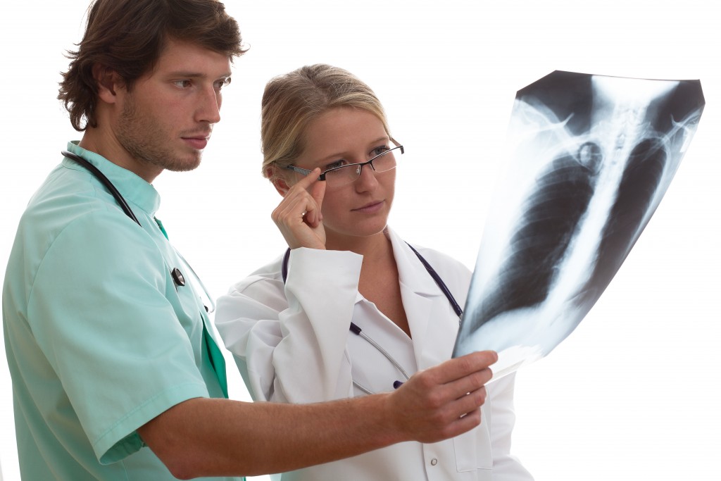 Radiologist showing x-ray of patient