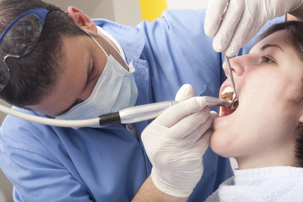 Dentist doing teeth cleaning on a patient