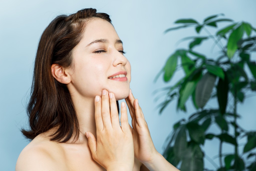 Woman touching her face