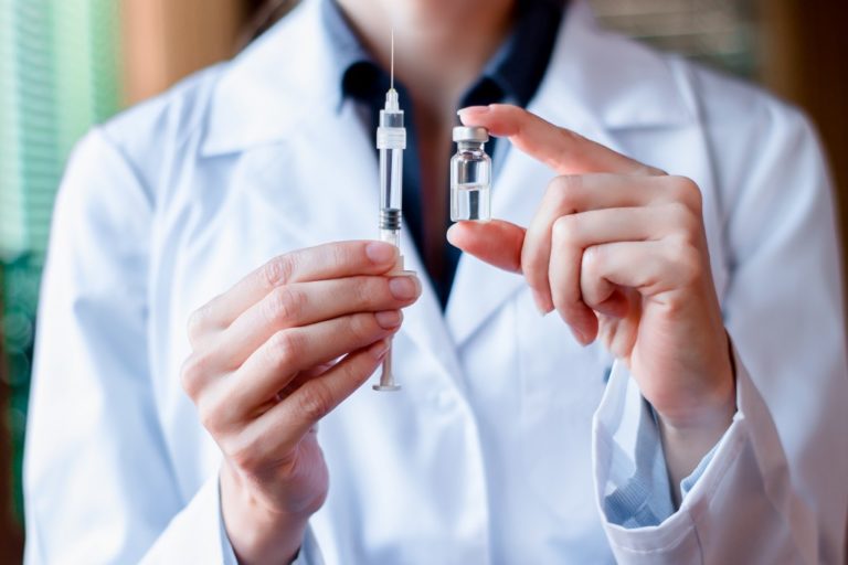 doctor holding vaccine