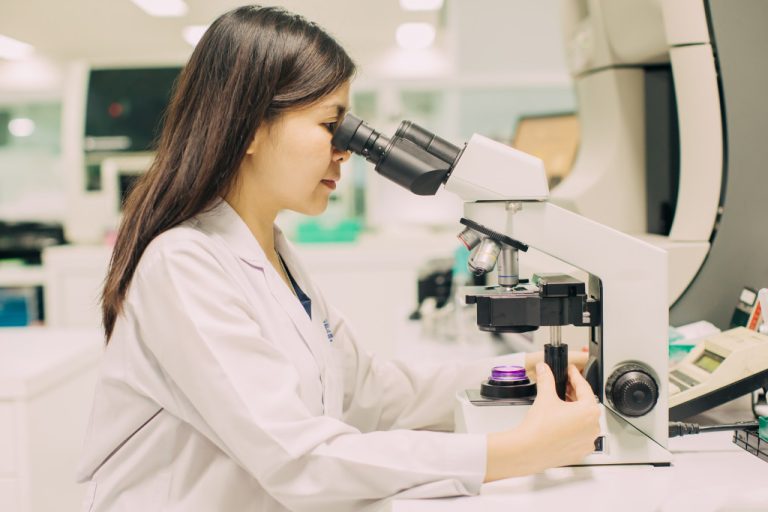 doctor looking at a microscope