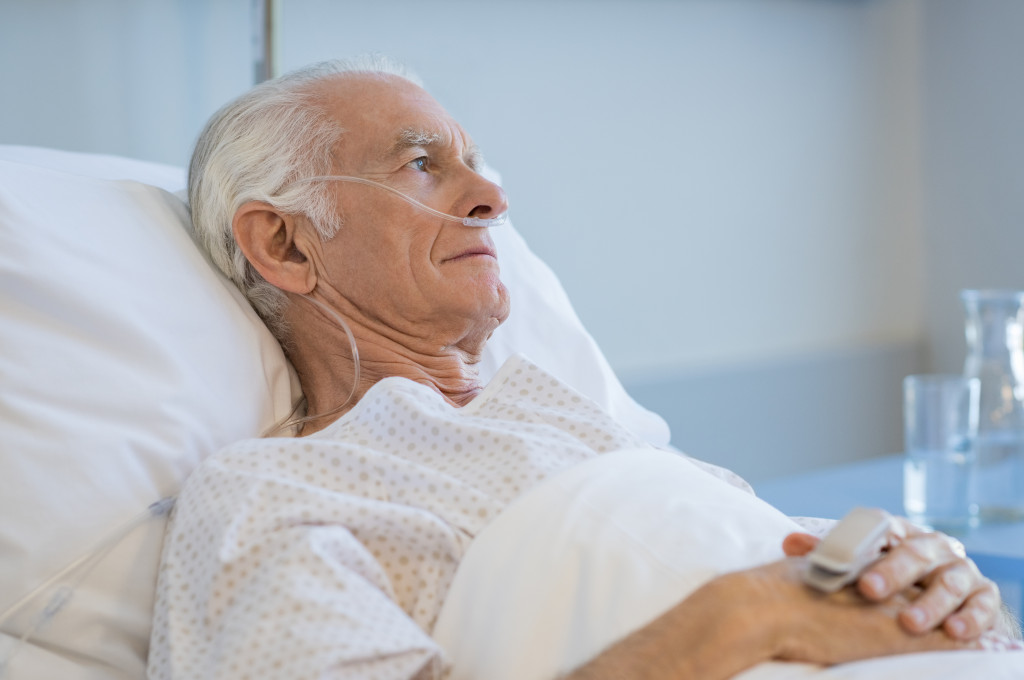 aged man lying in hospital bed